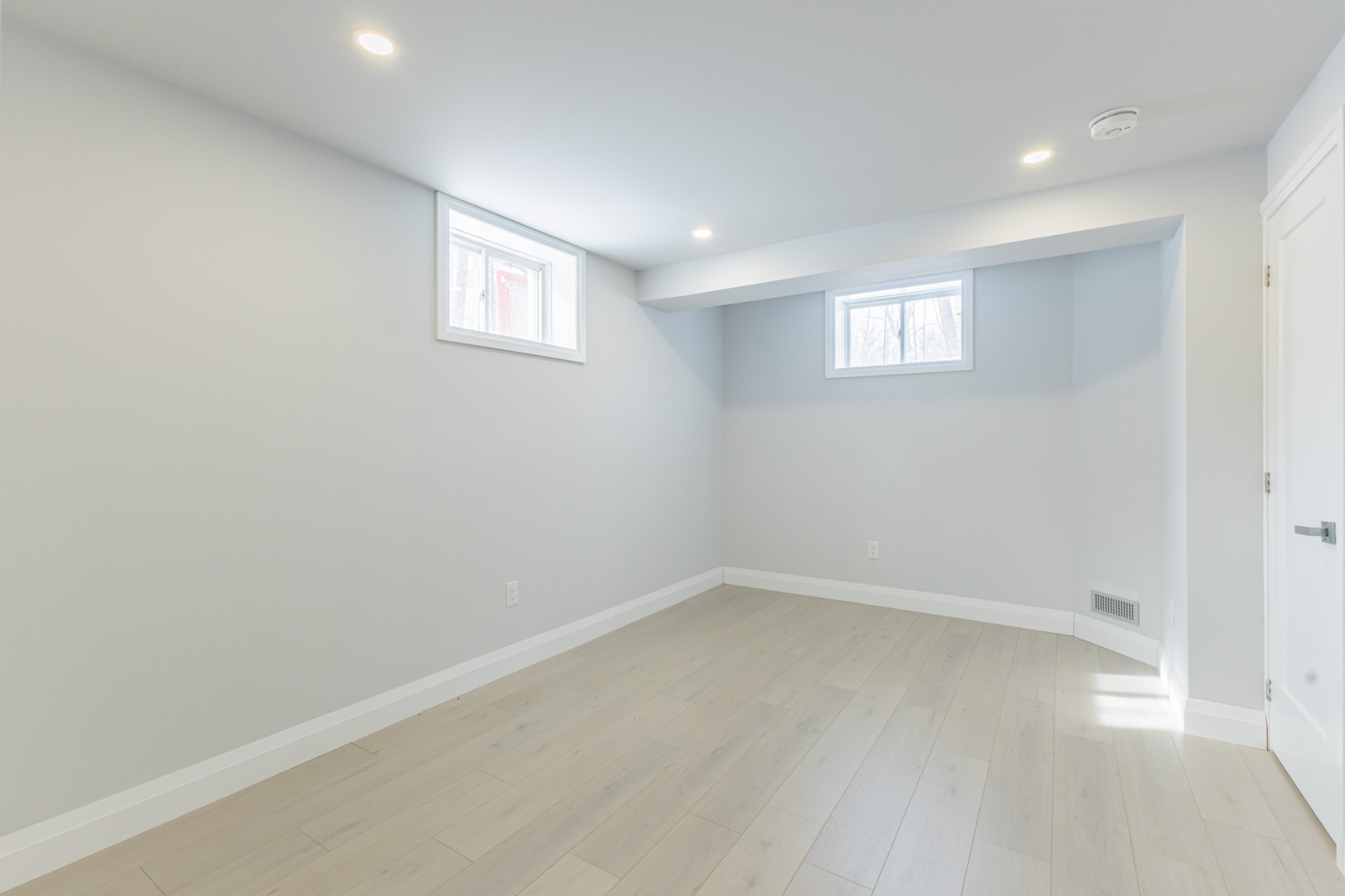 Legal basement bedroom with enlarged windows and fresh paint