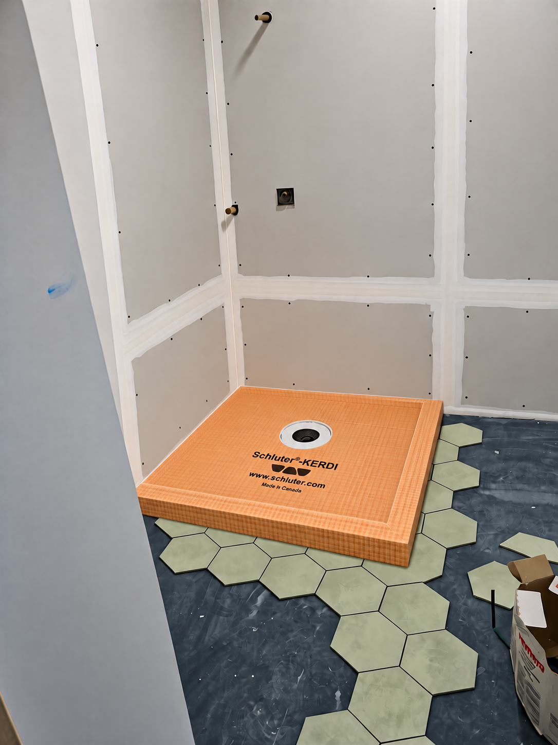 Schluter-KERDI shower pan installed against newly finished drywall before shower tiling