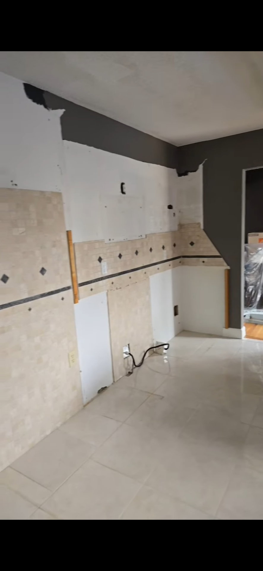 Old tile backsplash and cabinets stripped out during demolition