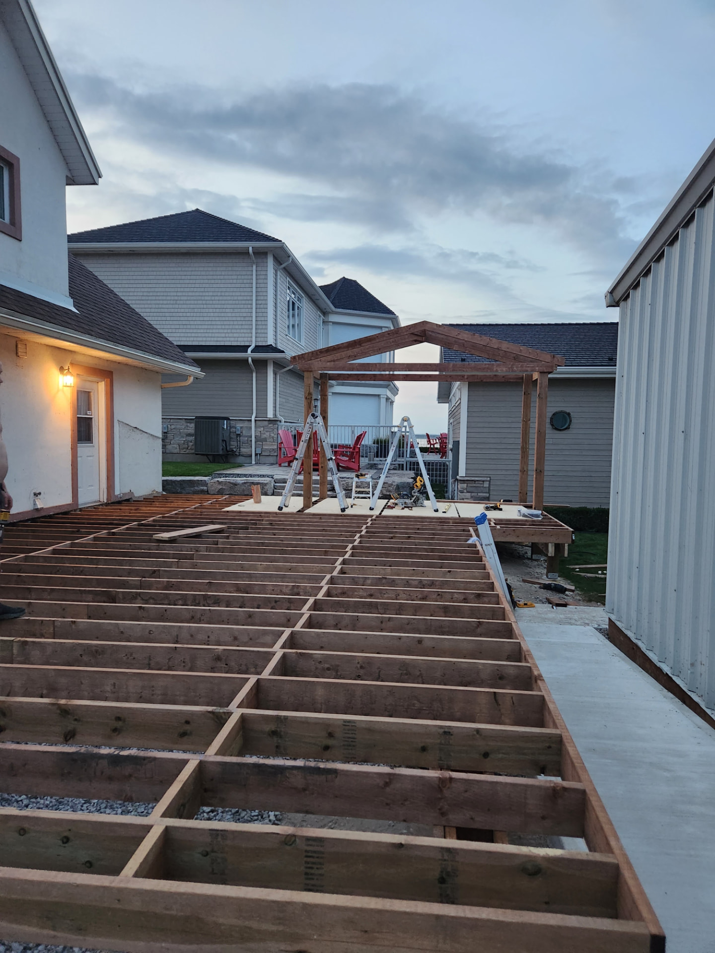 Pressure-treated deck framing and joists laid out with the pavilion posts set