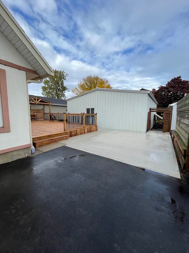 New privacy fence and gate alongside the deck and concrete patio