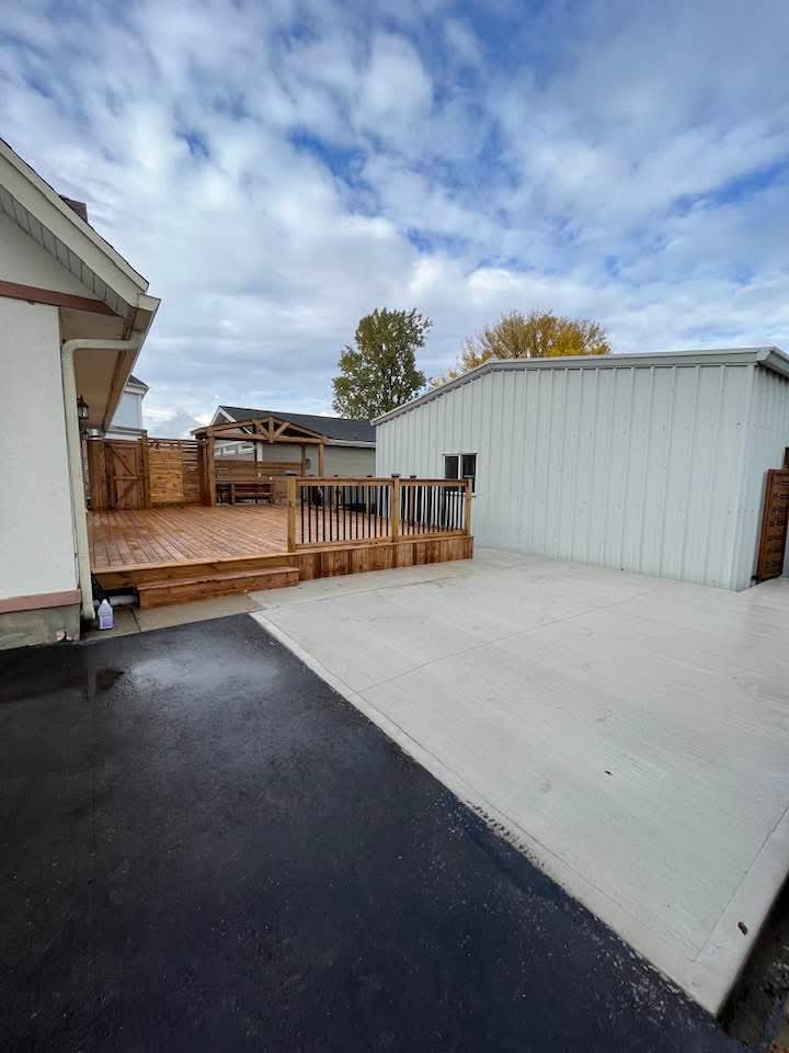 Completed deck, fence and concrete patio viewed from the driveway
